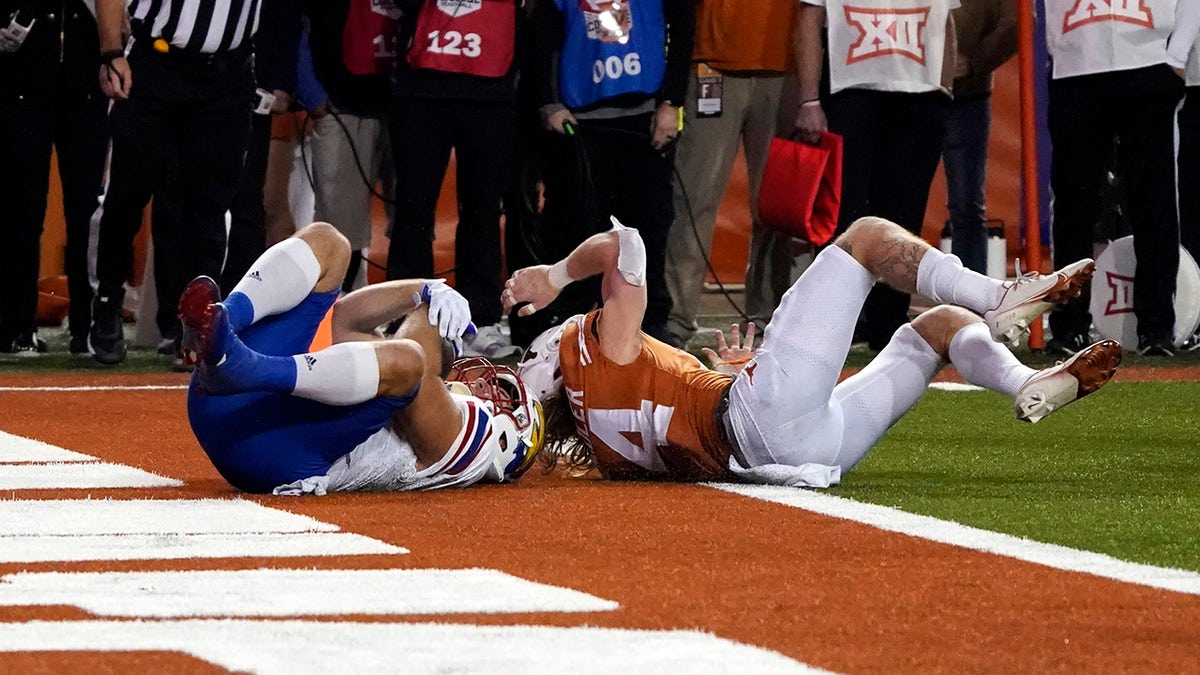 Kansas fullback Jared Casey catches a 2-point conversion past Texas defensive back Brenden Schooler to defeat Texas 57-56 in overtime in Austin, Texas, on Saturday, Nov. 13, 2021.