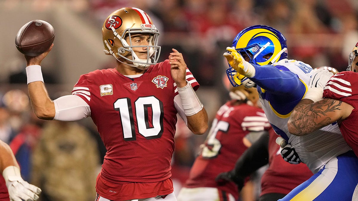 San Francisco 49ers quarterback Jimmy Garoppolo (10) passes against the Los Angeles Rams during the first half of an NFL football game in Santa Clara, California, Monday, Nov. 15, 2021.