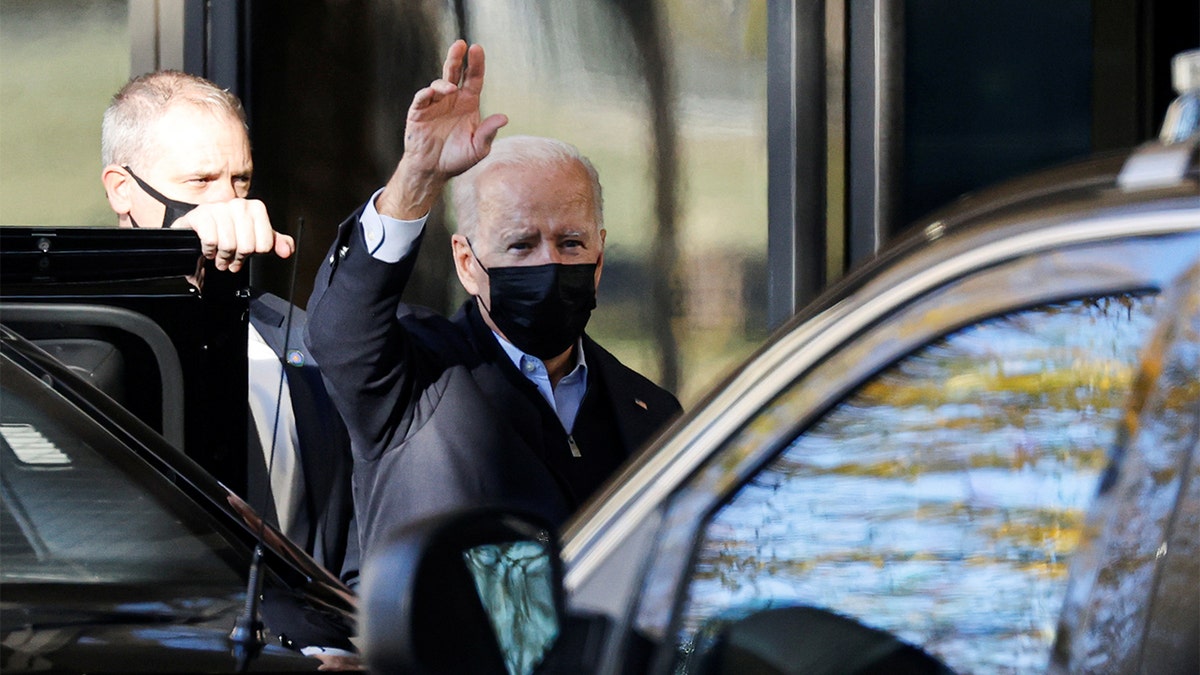President Biden waves to reporters as he arrives for his annual physical at Walter Reed National Military Medical Center in Bethesda, Maryland
