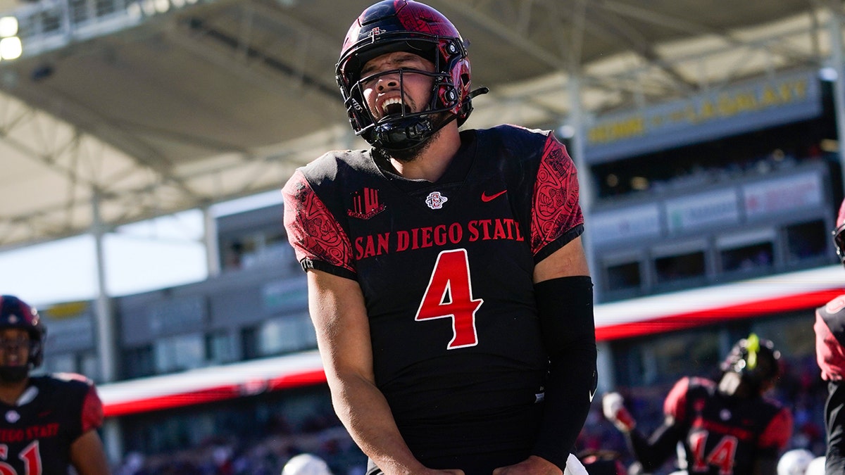 San Diego State quarterback Jordon Brookshire celebrates after scoring a touchdown during the second half of an NCAA college football game against the Boise State in Carson, California, Friday, Nov. 26, 2021.
