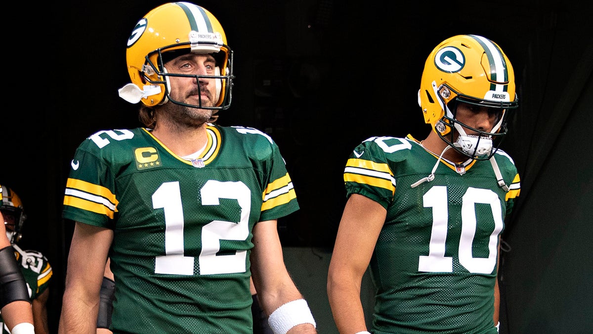 Aaron Rodgers and Jordan Love of the Packers walk onto the field before a game against the Detroit Lions at Lambeau Field on Sept. 20, 2021, in Green Bay, Wisconsin.  