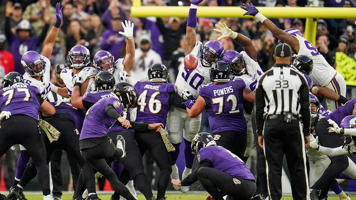 Baltimore Ravens kicker Justin Tucker (9) boots the winning field goal from the hold of punter Sam Koch during overtime against the Minnesota Vikings, Sunday, Nov. 7, 2021, in Baltimore.
