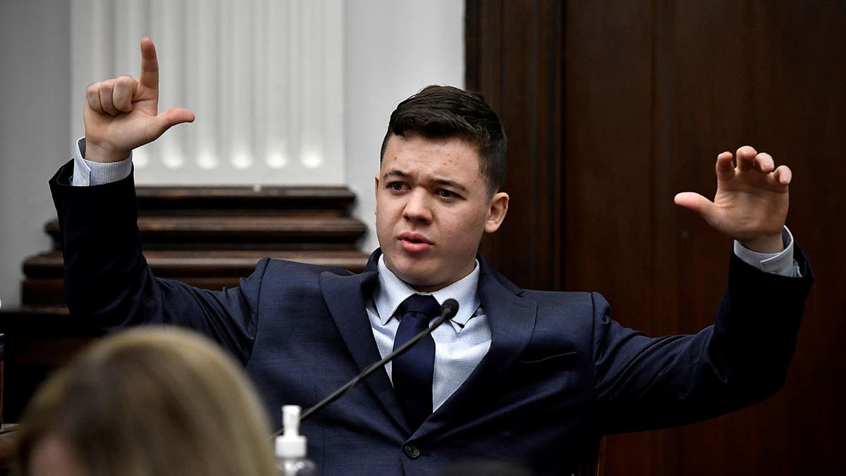 Kyle Rittenhouse talks about how Gaige Grosskreutz was holding his gun when Rittenhouse shot him on Aug. 25, 2020, while testifying during his trial at the Kenosha County Courthouse in Kenosha, Wisconsin, Nov. 10, 2021. 