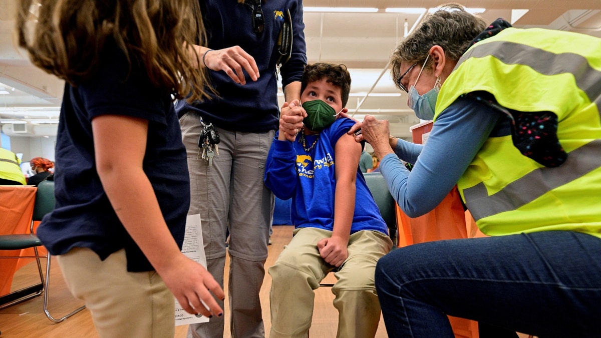 Child receives a dose of the Pfizer-BioNTech coronavirus disease (COVID-19) vaccine at Smoketown Family Wellness Center in Louisville, Kentucky