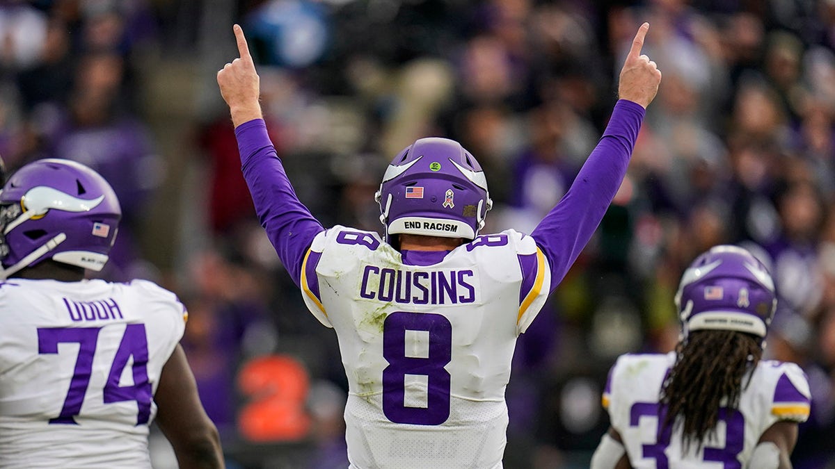 Minnesota Vikings quarterback Kirk Cousins (8) celebrates a touchdown pass during the second half against the Baltimore Ravens, Sunday, Nov. 7, 2021, in Baltimore.