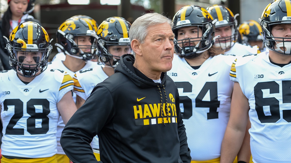 Head coach Kirk Ferentz of the Iowa Hawkeyes waits with the team before the game against the Nebraska Cornhuskers at Memorial Stadium on Nov. 26, 2021, in Lincoln, Nebraska.