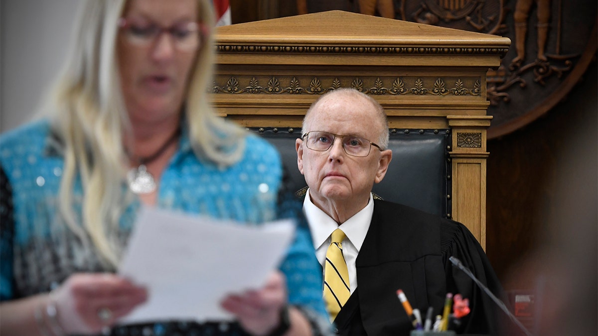 Judge Bruce Schroeder, right, listens as the verdicts are ready by Judicial Assistant Tami Mielcarek in Kyle Rittenhouse's trial at the Kenosha County Courthouse in Kenosha, Wis., on Friday, Nov. 19, 2021. The jury came back with its verdict afer close to 3 1/2 days of deliberation.  