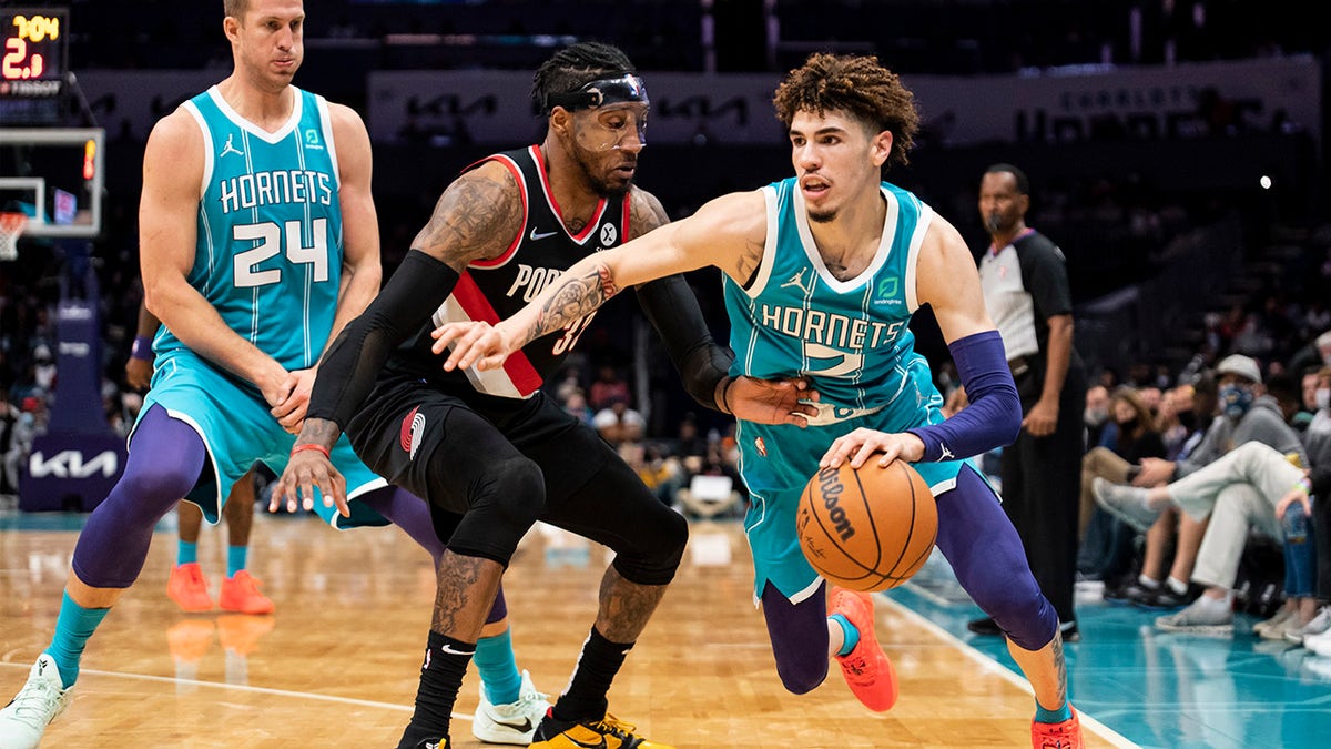 Charlotte Hornets guard LaMelo Ball (2) drives around Portland Trail Blazers forward Robert Covington (33) after Hornets center Mason Plumlee (24) set a screen Oct. 31, 2021, in Charlotte, N.C.