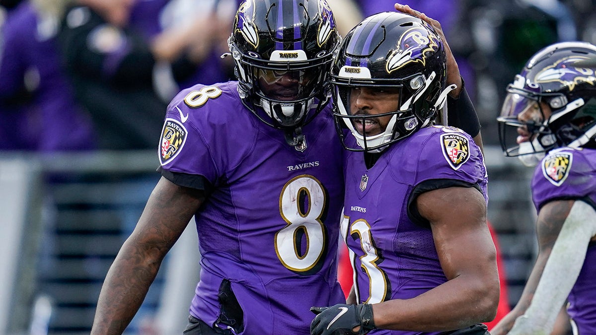 Baltimore Ravens quarterback Lamar Jackson (8) and wide receiver Devin Duvernay (13) celebrate after connecting for a touchdown during the second half against the Minnesota Vikings, Sunday, Nov. 7, 2021, in Baltimore.