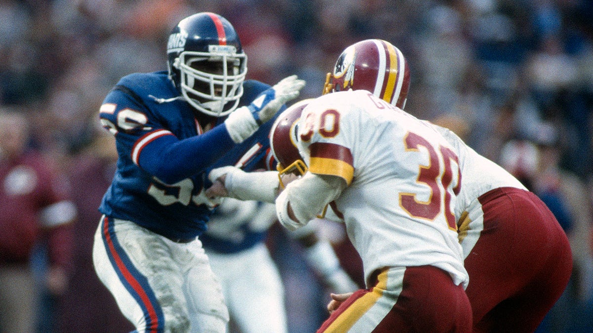 WASHINGTON, D.C. - DECEMBER 19:  Lawrence Taylor #56 of the New York Giants in action against the Washington Redskins during an NFL football game December 19, 1982 at RFK Stadium in Washington, D.C. Taylor played for the Giants from 1981-93.