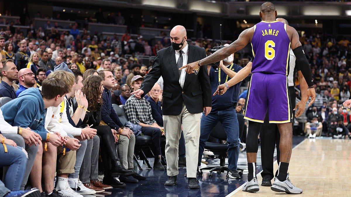 LeBron James of the Los Angeles Lakers points out fans that he had a disturbance with to security during the game against the Indiana Pacers at Gainbridge Fieldhouse on Nov. 24, 2021, in Indianapolis, Indiana.