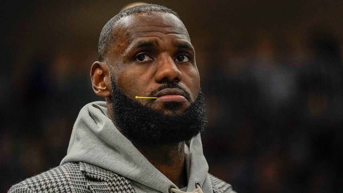 Los Angeles Lakers' LeBron James watches from the bench during the second half of an NBA basketball game against the Milwaukee Bucks Wednesday, Nov. 17, 2021, in Milwaukee.