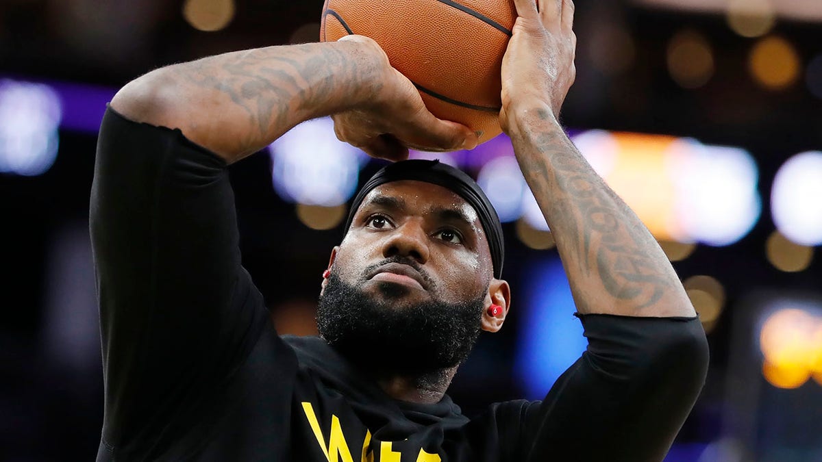 Los Angeles Lakers' LeBron James warms up before an NBA basketball game against the Boston Celtics, Friday, Nov. 19, 2021, in Boston.