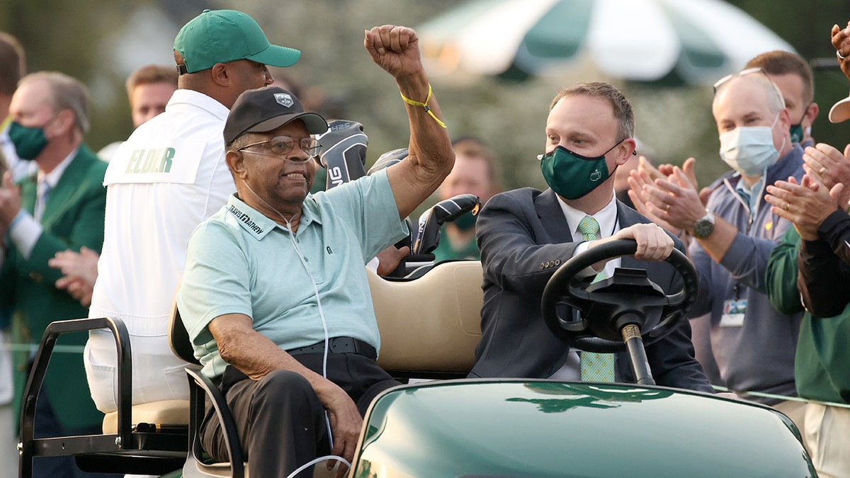 Honorary starter Lee Elder waves as he arrives to the opening ceremony of the Masters at Augusta National Golf Club on April 8, 2021, in Georgia.