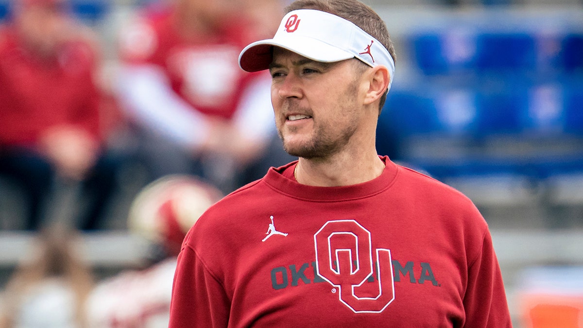 Lincoln Riley talks to his Oklahoma Sooner players before the Kansas Jayhawks game on Oct. 23, 2021, in Lawrence, Kansas.