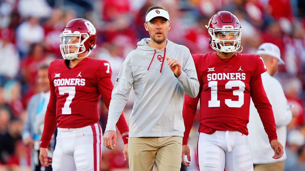 NORMAN, OK - OCTOBER 16: Head coach Lincoln Riley works with quarterback Spencer Rattler #7 and quarterback Caleb Williams #13 of the Oklahoma Sooners before a game against the Texas Christian University Horned Frogs at Gaylord Family Oklahoma Memorial Stadium on October 16, 2021 in Norman, Oklahoma. Oklahoma won 52-31.
