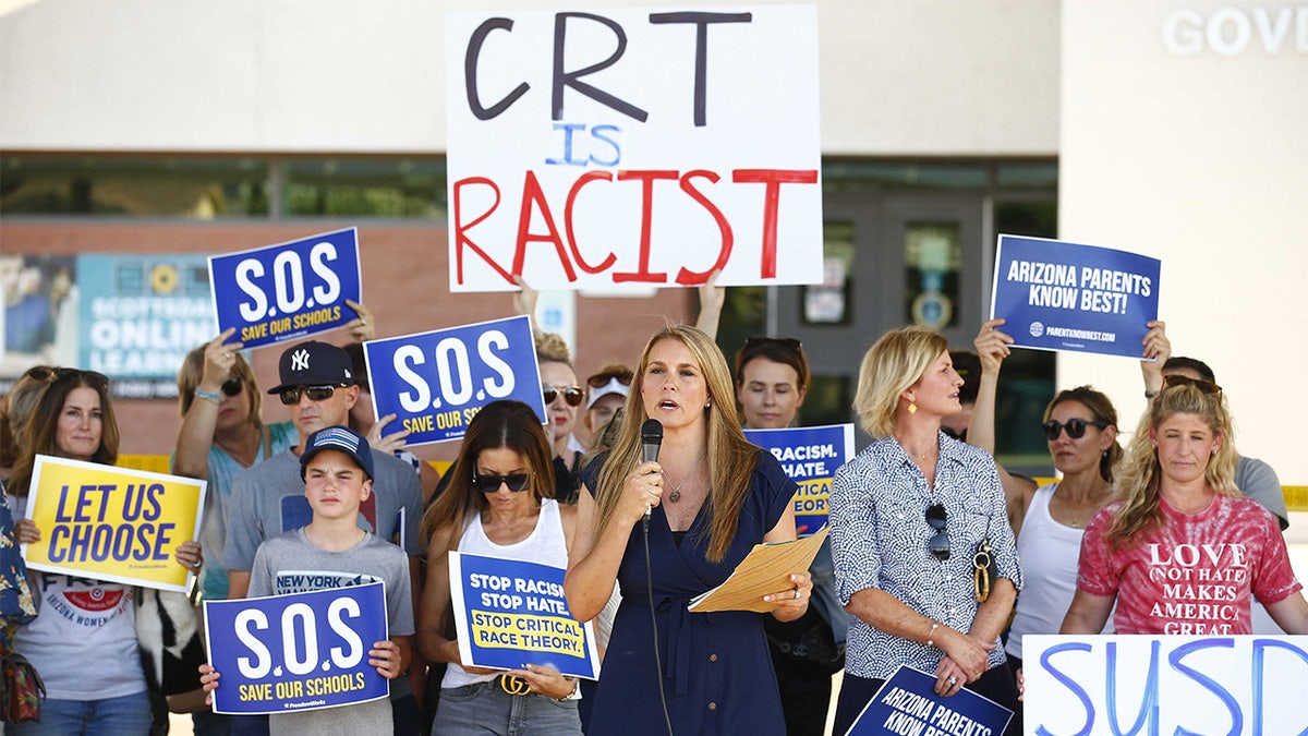 Amy Carney speaks on behalf of parents during a protest against critical race theory being taught at Scottsdale Unified School District before a digital school board meeting at Coronado High School in Scottsdale, Arizona, on May 24, 2021.
