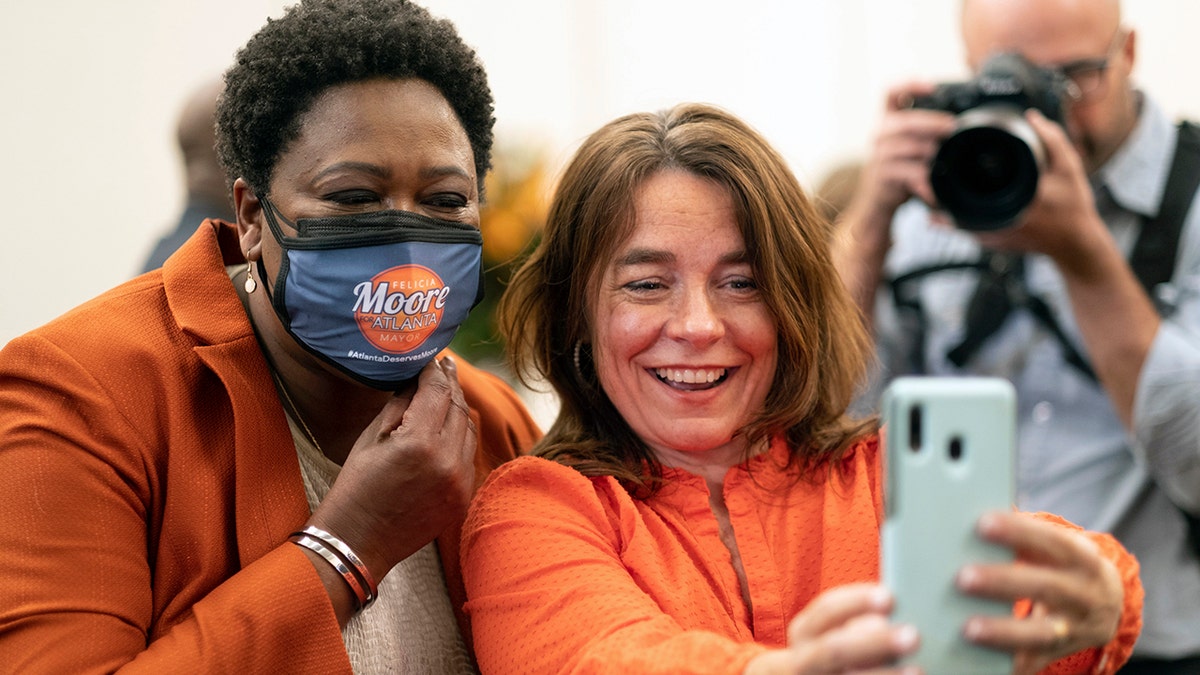 Felicia Moore, City Council president and mayoral candidate, left, takes a selfie with supporter Heidi Oquendo at her election night party Tuesday, Nov. 2, 2021 in Atlanta.
