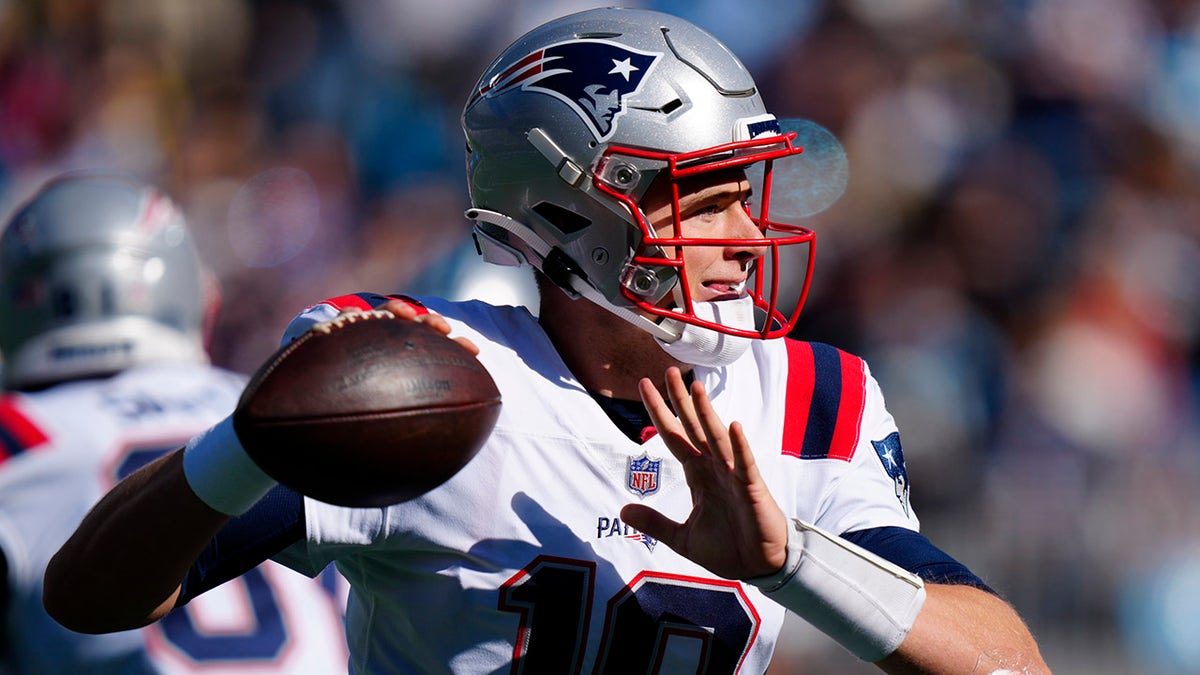 New England Patriots quarterback Mac Jones passes during the first half of an NFL football game against the Carolina Panthers Sunday, Nov. 7, 2021, in Charlotte, N.C.