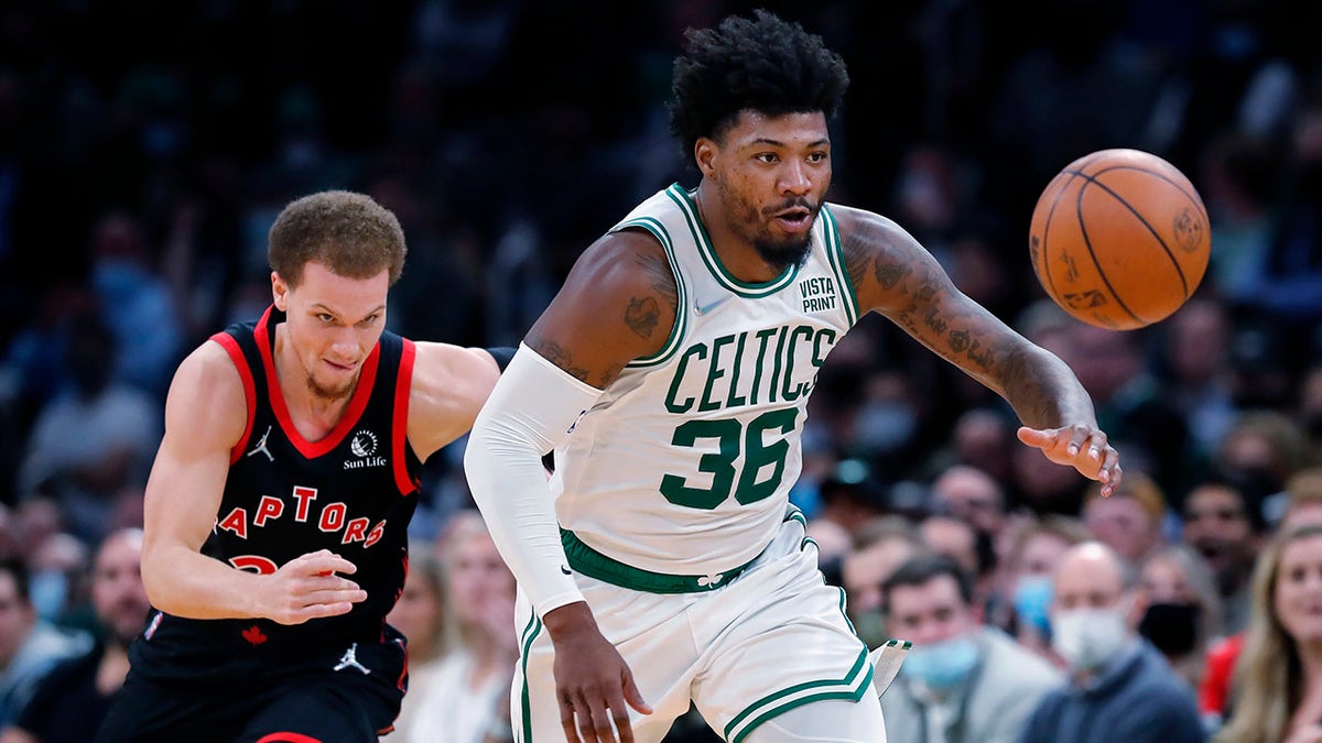 Boston Celtics' Marcus Smart (36) chases a loose ball in front of Toronto Raptors' Malachi Flynn during the first half of an NBA basketball game Wednesday, Nov. 10, 2021, in Boston.
