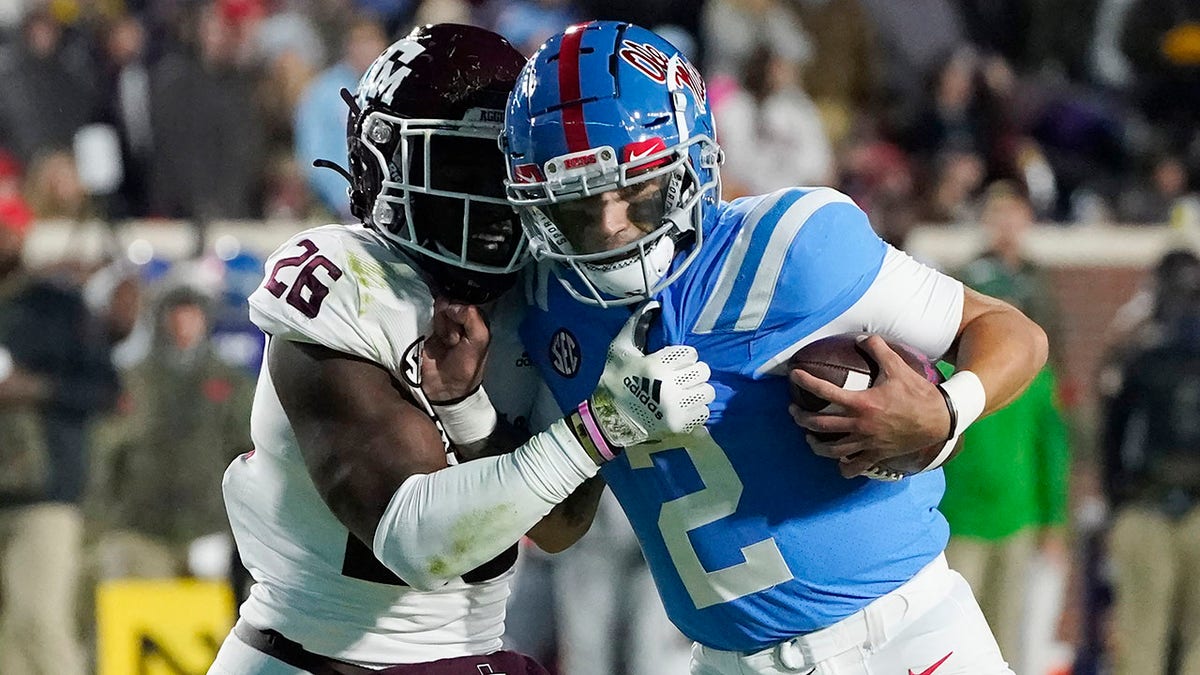Texas A&amp;amp;M defensive back Demani Richardson (26) attempts to strip the ball away from Mississippi quarterback Matt Corral (2) during the first half of an NCAA college football game, Saturday, Nov. 13, 2021, in Oxford, Miss.