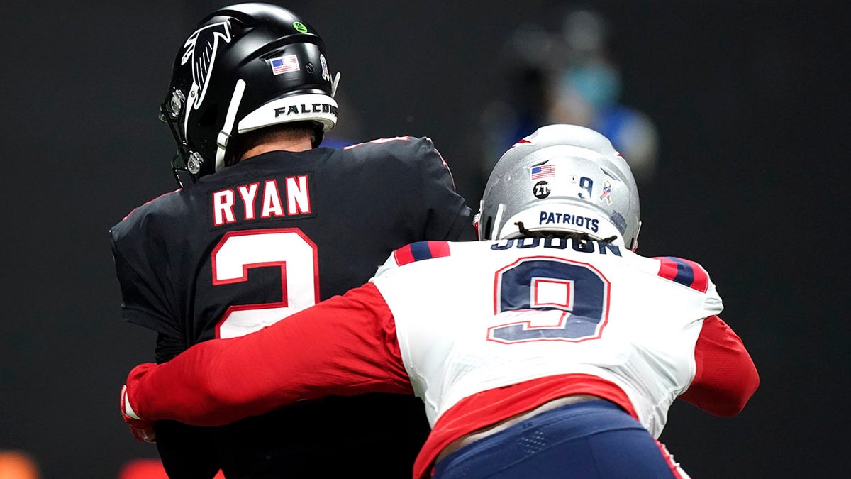 New England Patriots outside linebacker Matt Judon (9) sacks Atlanta Falcons quarterback Matt Ryan (2) during the first half of an NFL football game, Thursday, Nov. 18, 2021, in Atlanta.