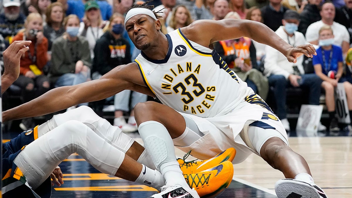 Utah Jazz center Rudy Gobert, left, pulls Indiana Pacers center Myles Turner (33) to the ground, leading to a fight during the second half of an NBA basketball game Thursday, Nov. 11, 2021, in Salt Lake City. Gobert and Turner were ejected.