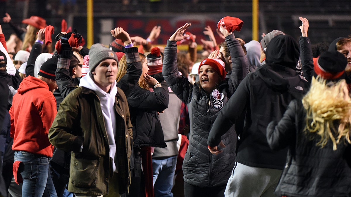 North Carolina State Wolfpack fans celebrate a win over the North Carolina Tar Heels during the second half at Carter-Finley Stadium Nov 26, 2021. 