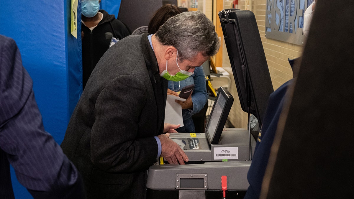 A Board of Election official opens the voting machine after Republican mayoral candidate Curtis Sliwa's ballot got stuck at a polling place on the Upper West Side on Nov. 2, 2021, in New York City. 