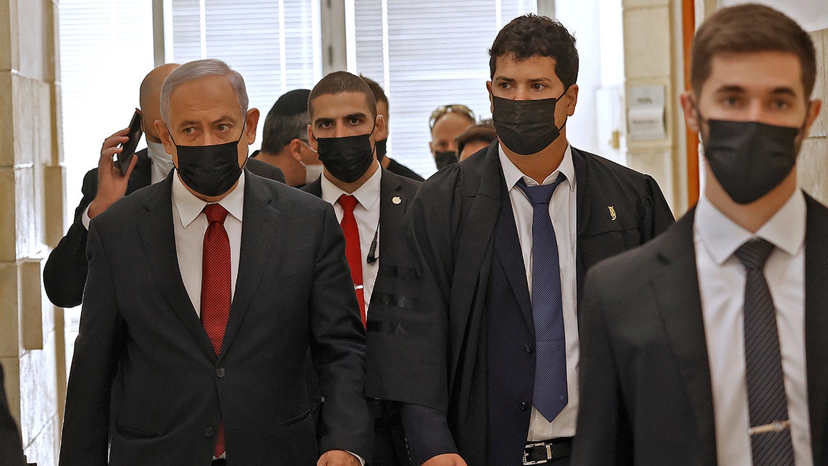 Former Israeli prime minister Benjamin Netanyahu, left, arrives for a court hearing on corruption charges on Tuesday, Nov. 16, 2021, in Jerusalem. 