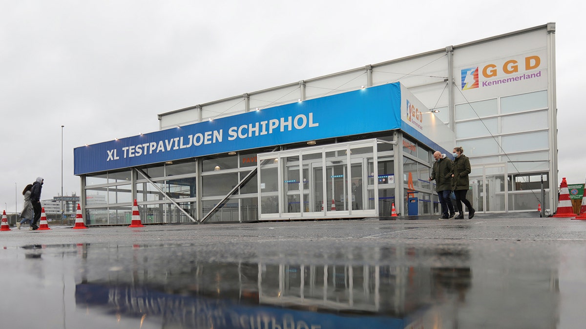People walk outside XL Schiphol test pavilion after Dutch health authorities said that 61 people who arrived in Amsterdam on flights from South Africa tested positive for COVID-19, in Amsterdam, Netherlands, November 27, 2021.