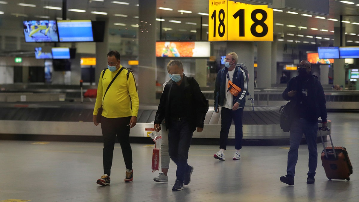 People walk inside Schiphol Airport after Dutch health authorities said that 61 people who arrived in Amsterdam on flights from South Africa tested positive for COVID-19, in Amsterdam, Netherlands, November 27, 2021. 