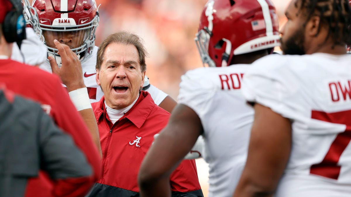 Alabama head coach Nick Saban talks with players in a time out during the first half of an NCAA college football game against Auburn Saturday, Nov. 27, 2021, in Auburn, Ala.