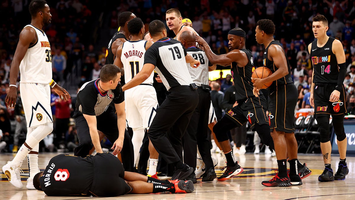 Markieff Morris #8 of the Miami Heat lays on the ground after being hit by Nikola Jokic #15 of the Denver Nuggets at Ball Arena on Nov. 8, 2021 in Denver, Colorado.