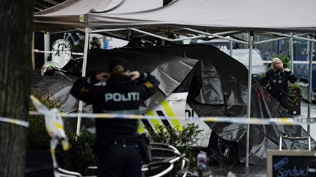 Police cover a car after a person was shot in the Bislett neighborhood of Oslo on Tuesday.