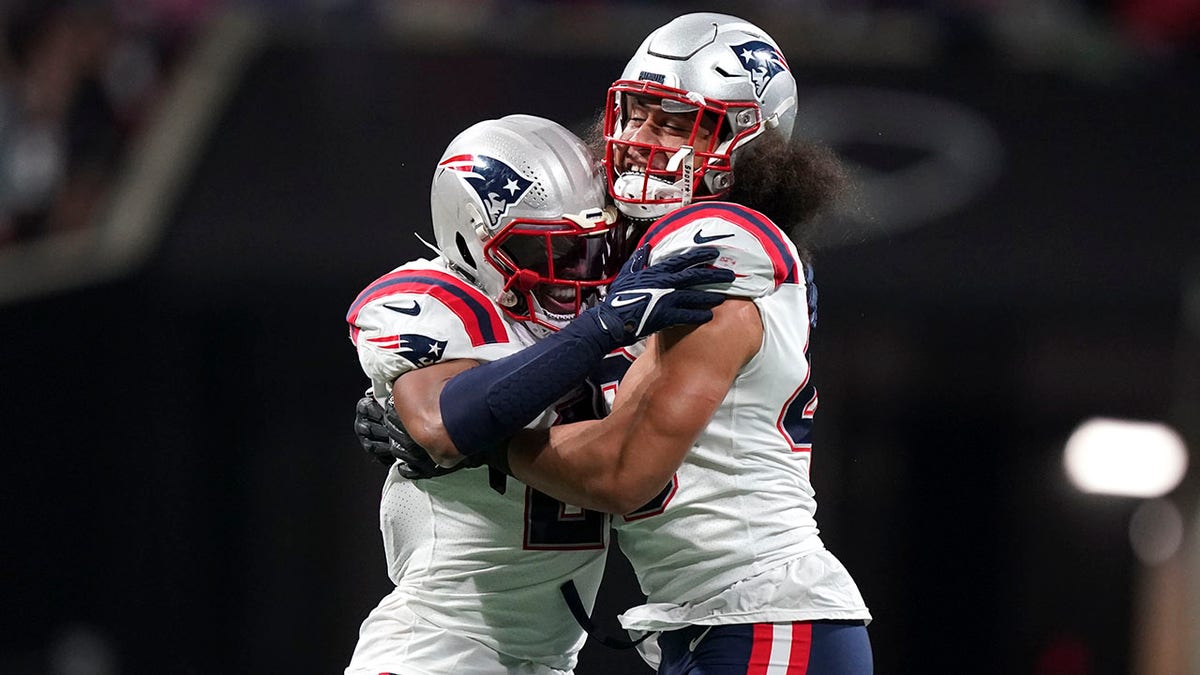 New England Patriots linebacker Jahlani Tavai (48) and New England Patriots safety Adrian Phillips (21) celebrate a defense of stop of the Atlanta Falcons during the second half of an NFL football game, Thursday, Nov. 18, 2021, in Atlanta.