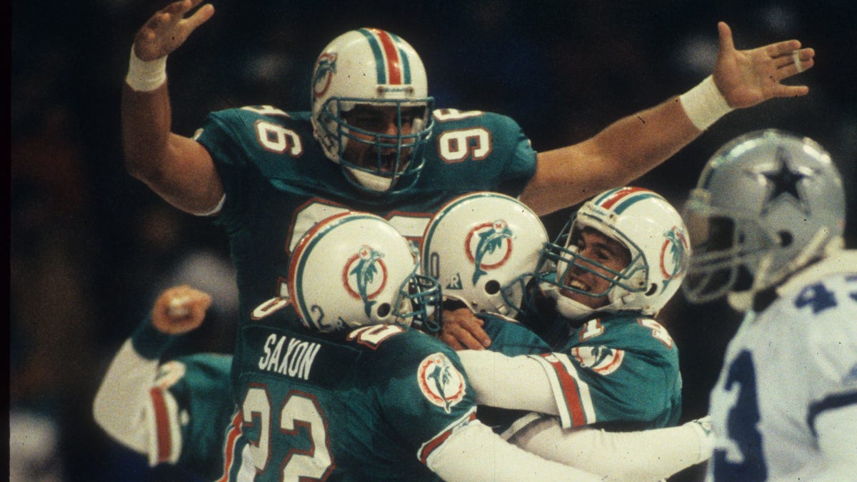 The Miami Dolphins celebrate after kicker Pete Stoyanovich's game-winning, 19-yard kick against the Dallas Cowboys at Texas Stadium on Nov. 25, 1993, in Irving, Texas. 