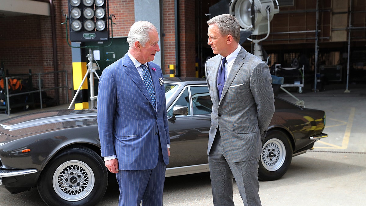Prince Charles, Prince of Wales meets with actor Daniel Craig during a visit to the James Bond set at Pinewood Studios on June 20, 2019 in Iver Heath, England. The studio reportedly caught fire on Thursday night after residents reported hearing a ‘very big explosion’ followed by smoke. 