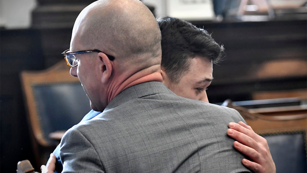 Kyle Rittenhouse hugs one of his attorneys, Corey Chirafisi, after he is found not guilty on all counts at the Kenosha County Courthouse in Kenosha, Wis., on Friday, Nov. 19, 2021.  The jury came back with its verdict afer close to 3 1/2 days of deliberation.  (Sean Krajacic/The Kenosha News via AP, Pool)