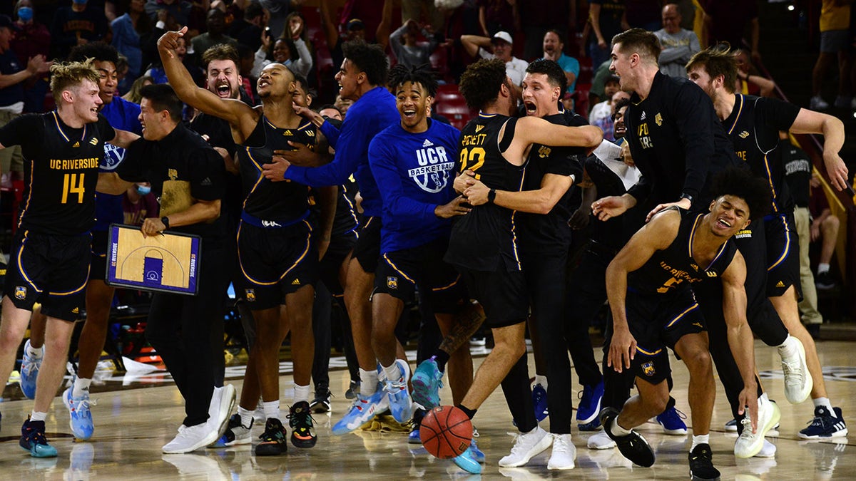 Nov 11, 2021; Tempe, Arizona, USA;  UC Riverside Highlanders players celebrate a buzzer beater against the Arizona State Sun Devils by Highlanders forward J.P. Moorman II (1) during the second half at Desert Financial Arena.