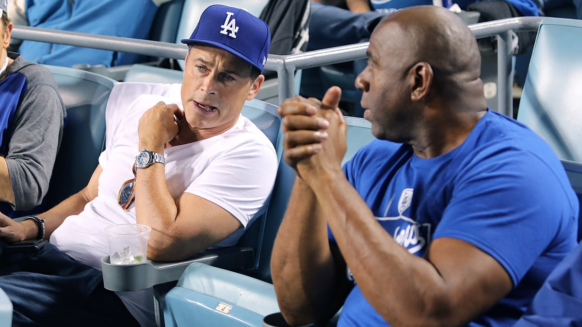 Rob Lowe and Magic Johnson attend Game 3 of the World Series between the Los Angeles Dodgers and Boston Red Sox at Dodger Stadium Oct. 26, 2018, in Los Angeles.