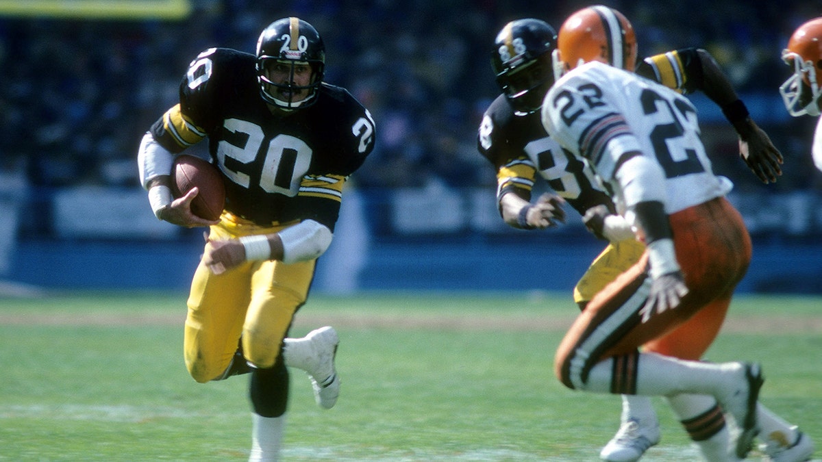 Running back Rocky Bleier (20) of the Pittsburgh Steelers carries the ball looking to get a block from teammate Lynn Swann (88) on Clarence R. Scott (22) of the Cleveland Browns circa late 1970s during an NFL football game at Cleveland Municipal Stadium in Cleveland, Ohio. 