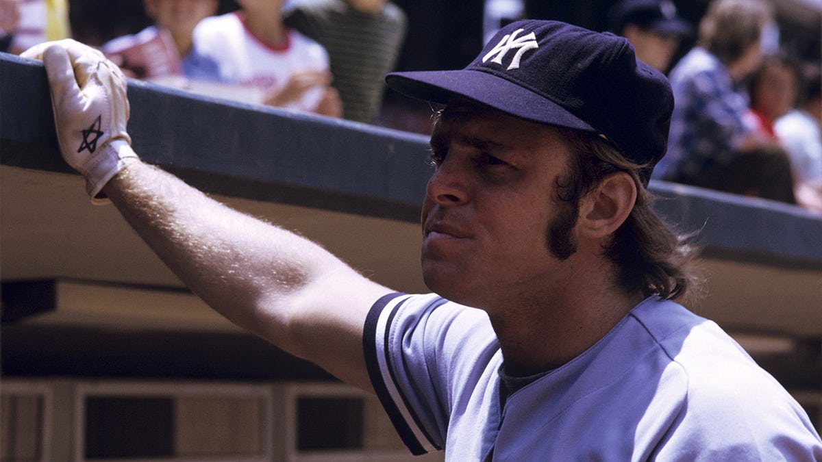 First baseman Ron Blomberg of the New York Yankees looks into the crowd with his hand against the facing of the roof of the dugout prior to a doubleheader on June 17, 1973, against the California Angels at Anaheim Stadium in Anaheim, California.