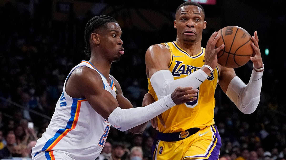 Los Angeles Lakers guard Russell Westbrook, right, is defended by Oklahoma City Thunder guard Shai Gilgeous-Alexander during the first half of an NBA basketball game Thursday, Nov. 4, 2021, in Los Angeles.