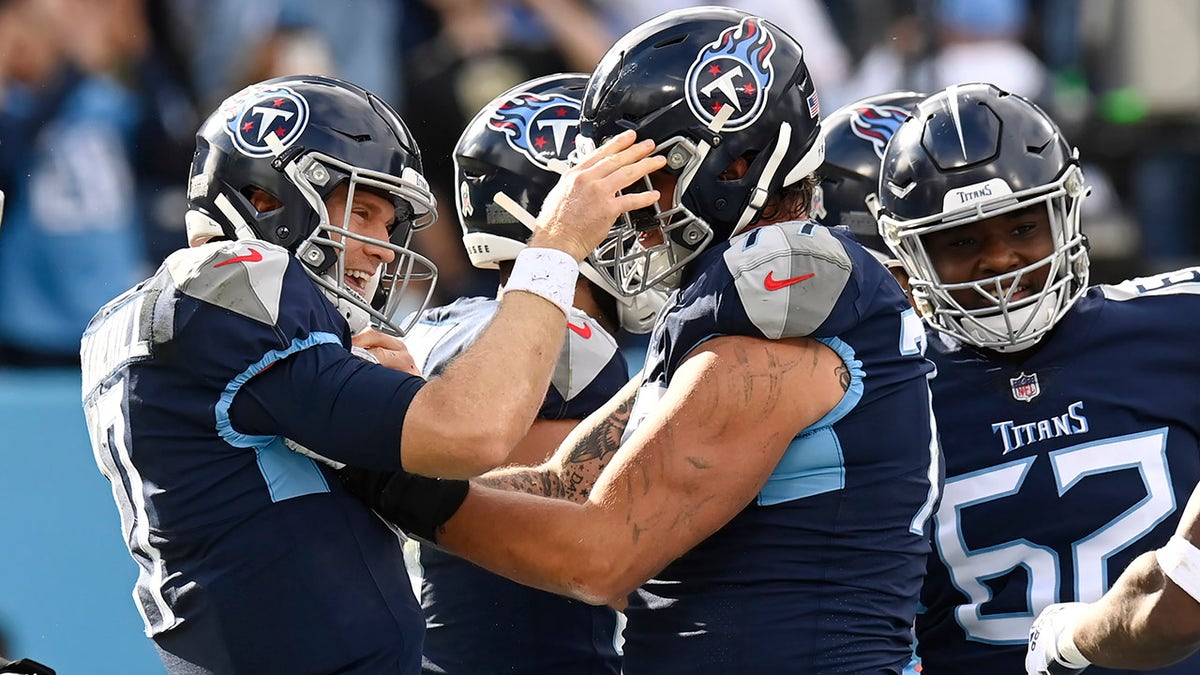 Tennessee Titans quarterback Ryan Tannehill, left, celebrates after scoring a touchdown on a 1-yard run against the New Orleans Saints in the first half of an NFL football game Sunday, Nov. 14, 2021, in Nashville, Tennessee. 
