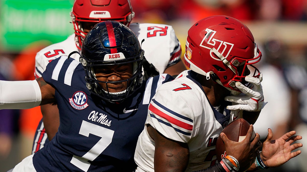 Liberty quarterback Malik Willis (7) is tackled for a loss by Mississippi defensive lineman Sam Williams (7) during the first half of an NCAA college football game in Oxford, Miss., Saturday, Nov. 6, 2021. 