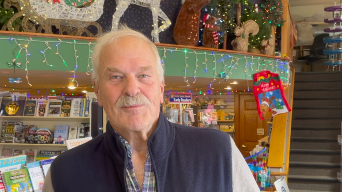 Norman Bruce, the owner of Martha Merrell's Books and Toys, opened his doors to frightened parade-goers after the assault.