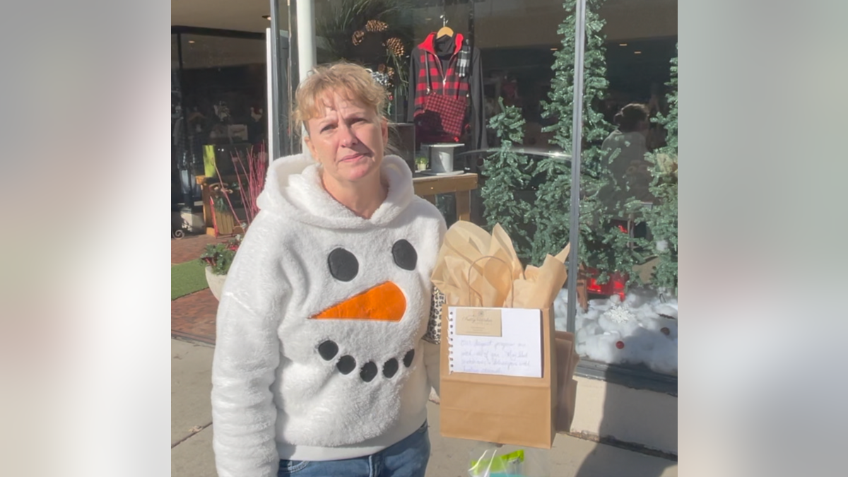 A local woman named Carrie on her way to deliver a gift to victims of the Christmas parade attack