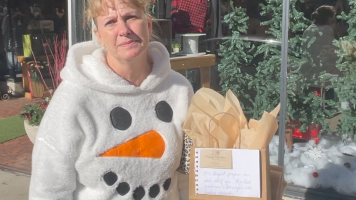 A local woman named Carrie on her way to deliver a gift to victims of the Christmas parade attack