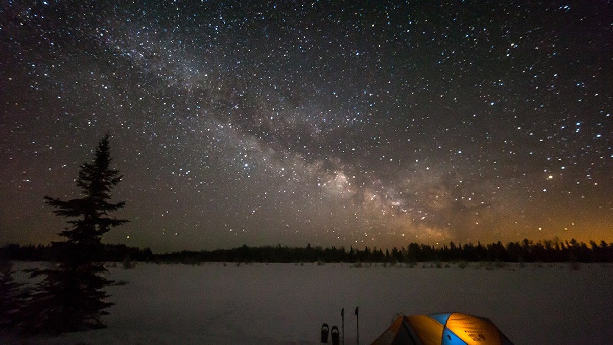 Tent camping under a rising Milky Way in Voyegeur's National Park in Minnesota.